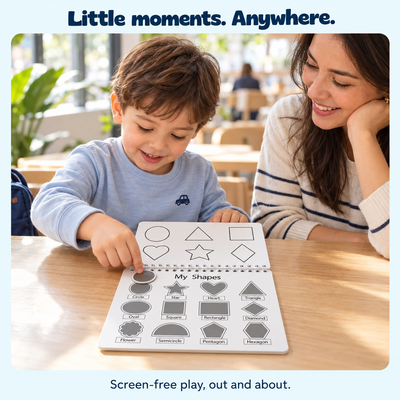 Illustrative café scene showing a child playing with the Busy Book beside a parent.